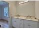 Bathroom with double sink vanity, stone countertop, and modern fixtures at 627 Georgetown Rd, Raleigh, NC 27608