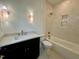Bathroom with vanity, stone countertop, tub, and shower featuring neutral tile at 627 Georgetown Rd, Raleigh, NC 27608