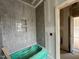 Gray tiled bathroom showcasing tub, tiled niche and bright lighting at 627 Georgetown Rd, Raleigh, NC 27608