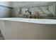 Close up of tub with waterfall faucet and marble tile at 627 Georgetown Rd, Raleigh, NC 27608