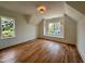 Bright bedroom featuring hardwood floors, white walls, natural light, and modern lighting at 627 Georgetown Rd, Raleigh, NC 27608