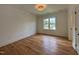 Light-filled bedroom with hardwood floors and large window, ideal for relaxation at 627 Georgetown Rd, Raleigh, NC 27608