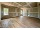 Spacious bedroom featuring newly installed hardwood floors and two bright windows at 627 Georgetown Rd, Raleigh, NC 27608