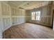 A bright bedroom showcasing wood flooring and natural light through a large window at 627 Georgetown Rd, Raleigh, NC 27608