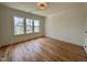Sunlit bedroom showcasing hardwood floors and a view of the neighborhood at 627 Georgetown Rd, Raleigh, NC 27608