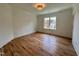 Bright bedroom with wood floors, white trim, and view of the neighborhood at 627 Georgetown Rd, Raleigh, NC 27608