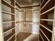 Walk-in closet with custom shelving and hanging rods at 627 Georgetown Rd, Raleigh, NC 27608