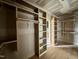 Walk-in closet featuring custom shelving and hanging rods at 627 Georgetown Rd, Raleigh, NC 27608