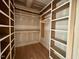 Walk-in closet with custom shelving and hanging rods at 627 Georgetown Rd, Raleigh, NC 27608
