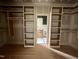Walk-in closet with custom shelving and hanging rods at 627 Georgetown Rd, Raleigh, NC 27608