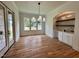 Dining area with a bar area, custom cabinetry, hardwood floors and a modern chandelier at 627 Georgetown Rd, Raleigh, NC 27608