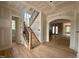 A view of the entryway with a staircase featuring wood treads and iron spindles leading to the upper level at 627 Georgetown Rd, Raleigh, NC 27608