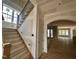 A view of the entryway with a staircase featuring wood treads and iron spindles leading to the upper level at 627 Georgetown Rd, Raleigh, NC 27608