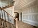 A view of the entryway featuring wood treads and iron spindles leading to the upper level at 627 Georgetown Rd, Raleigh, NC 27608