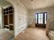 A foyer featuring hardwood floors, built-in shelving, and a dark wood front door at 627 Georgetown Rd, Raleigh, NC 27608