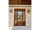 Elegant wooden front door with sidelights, gas lanterns and light brick at 627 Georgetown Rd, Raleigh, NC 27608