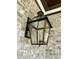 Gas lantern on a light brick exterior wall at 627 Georgetown Rd, Raleigh, NC 27608