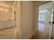 Hallway view into a bathroom with a vanity and into a bedroom with a bench seat at 627 Georgetown Rd, Raleigh, NC 27608