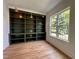 Home office featuring built-in bookshelves, hardwood floors, and natural light at 627 Georgetown Rd, Raleigh, NC 27608
