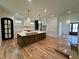 Spacious kitchen features a large island, hardwood flooring, custom cabinetry and modern lighting at 627 Georgetown Rd, Raleigh, NC 27608