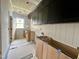 Bright laundry room featuring custom cabinets and tiled flooring ready for appliances at 627 Georgetown Rd, Raleigh, NC 27608