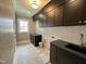 Bright laundry room featuring black cabinets, neutral walls, and modern finishes at 627 Georgetown Rd, Raleigh, NC 27608