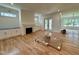 Bright living room with a fireplace, hardwood floors, built-in cabinets, and French doors to the yard at 627 Georgetown Rd, Raleigh, NC 27608