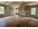 Main bedroom with hardwood floors and multiple windows, awaiting personal touches at 627 Georgetown Rd, Raleigh, NC 27608