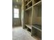 Well organized mudroom featuring brick floors, built in storage and a window at 627 Georgetown Rd, Raleigh, NC 27608