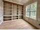 Office space with built-in shelving, hardwood floors, and a bright window at 627 Georgetown Rd, Raleigh, NC 27608