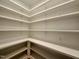 Bright pantry featuring ample white shelving for plenty of storage at 627 Georgetown Rd, Raleigh, NC 27608