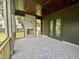 Large porch with brick floors, stone fireplace, ceiling fan, and views of backyard at 627 Georgetown Rd, Raleigh, NC 27608