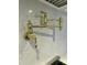 Stylish gold pot filler faucet mounted on a marble backsplash, enhancing kitchen functionality at 627 Georgetown Rd, Raleigh, NC 27608