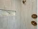 Close up of tiled shower with gold fixtures at 627 Georgetown Rd, Raleigh, NC 27608