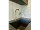 Close-up of a sink with modern faucet and dark stone countertop at 627 Georgetown Rd, Raleigh, NC 27608