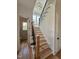 Staircase with black metal railing, hardwood treads, and abundant natural light at 627 Georgetown Rd, Raleigh, NC 27608