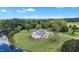 Aerial view of a stunning home with a lake, surrounded by mature trees and expansive green space at 1618 Ben Wilson Rd, Mebane, NC 27302