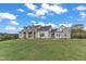 Charming two-story home with a stone and white exterior, well-manicured lawn, and a serene setting at 1618 Ben Wilson Rd, Mebane, NC 27302