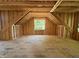 Unfinished attic space featuring open stud framing and flooring at 208 E Whitaker Mill Rd, Raleigh, NC 27608