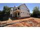 New construction two-story home showing exterior framing and brick foundation at 208 E Whitaker Mill Rd, Raleigh, NC 27608