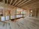 Large unfinished interior showing stud framing, stairway and flooring at 208 E Whitaker Mill Rd, Raleigh, NC 27608