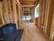 Unfinished interior featuring the stud framing, plumbing, and flooring at 208 E Whitaker Mill Rd, Raleigh, NC 27608