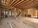 Unfinished interior showcasing the stud framing, flooring, stairs, and fireplace at 208 E Whitaker Mill Rd, Raleigh, NC 27608