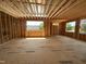 Unfinished living room showing the framing, windows, and subflooring, showcasing the open design at 208 E Whitaker Mill Rd, Raleigh, NC 27608