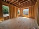 Unfinished new room with stud framing, flooring, and windows at 208 E Whitaker Mill Rd, Raleigh, NC 27608