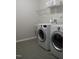 Bright laundry room with washer, dryer, and shelving at 609 Meadowgrass Ln, Wake Forest, NC 27587