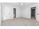 Neutral bedroom features white walls, neutral carpet, a ceiling fan, and access to an ensuite bath at 6413 English Oaks Dr, Raleigh, NC 27615