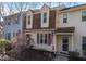 Front exterior of townhome with dormer windows and landscaped front yard at 6413 English Oaks Dr, Raleigh, NC 27615