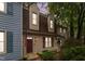 Charming home with manicured landscaping, red door, shuttered windows, and patriotic American flags on display at 6413 English Oaks Dr, Raleigh, NC 27615