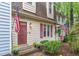 Charming home features a cozy front entrance with flowers and two American flags at 6413 English Oaks Dr, Raleigh, NC 27615